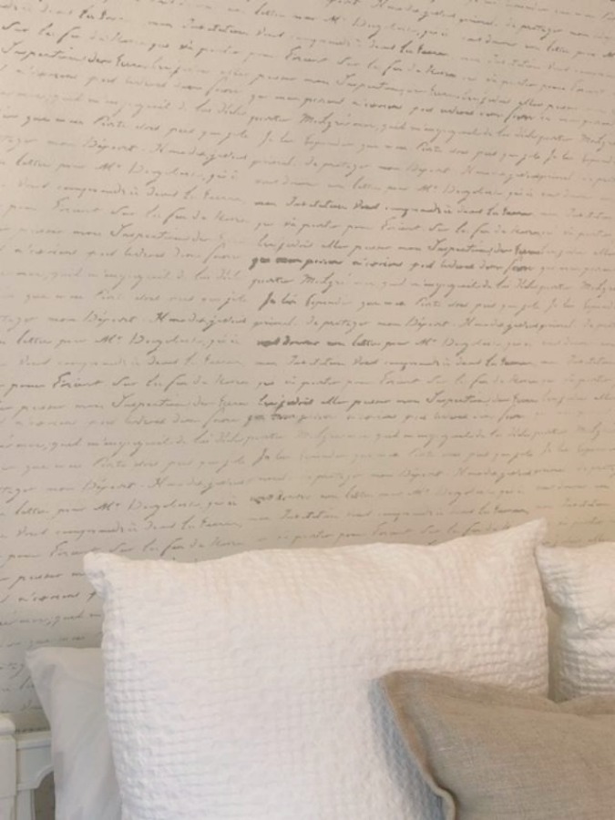 DIY Chic French Script Stenciled Accent Wall. Country French farmhouse style bedroom with French script stenciled wall by Hello Lovely Studio. #frenchcountry #frenchfarmhouse #frenchscript #diy #stenciledwall