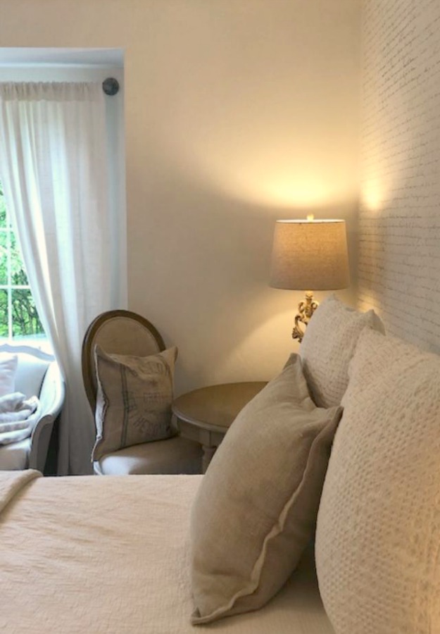 DIY Chic French Script Stenciled Accent Wall. Country French farmhouse style bedroom with French script stenciled wall by Hello Lovely Studio. #frenchcountry #frenchfarmhouse #frenchscript #diy #stenciledwall