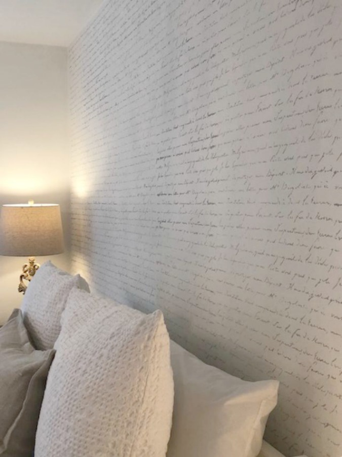 DIY Chic French Script Stenciled Accent Wall. Country French farmhouse style bedroom with French script stenciled wall by Hello Lovely Studio. #frenchcountry #frenchfarmhouse #frenchscript #diy #stenciledwall
