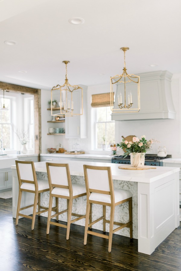 Elegant white farmhouse kitchen with Benjamin Moore Repose Grey cabinets, subway tile, gold accents, and reclaimed barn wood. Design: Finding Lovely. Wall color: Benjamin Moore Chantilly Lace.