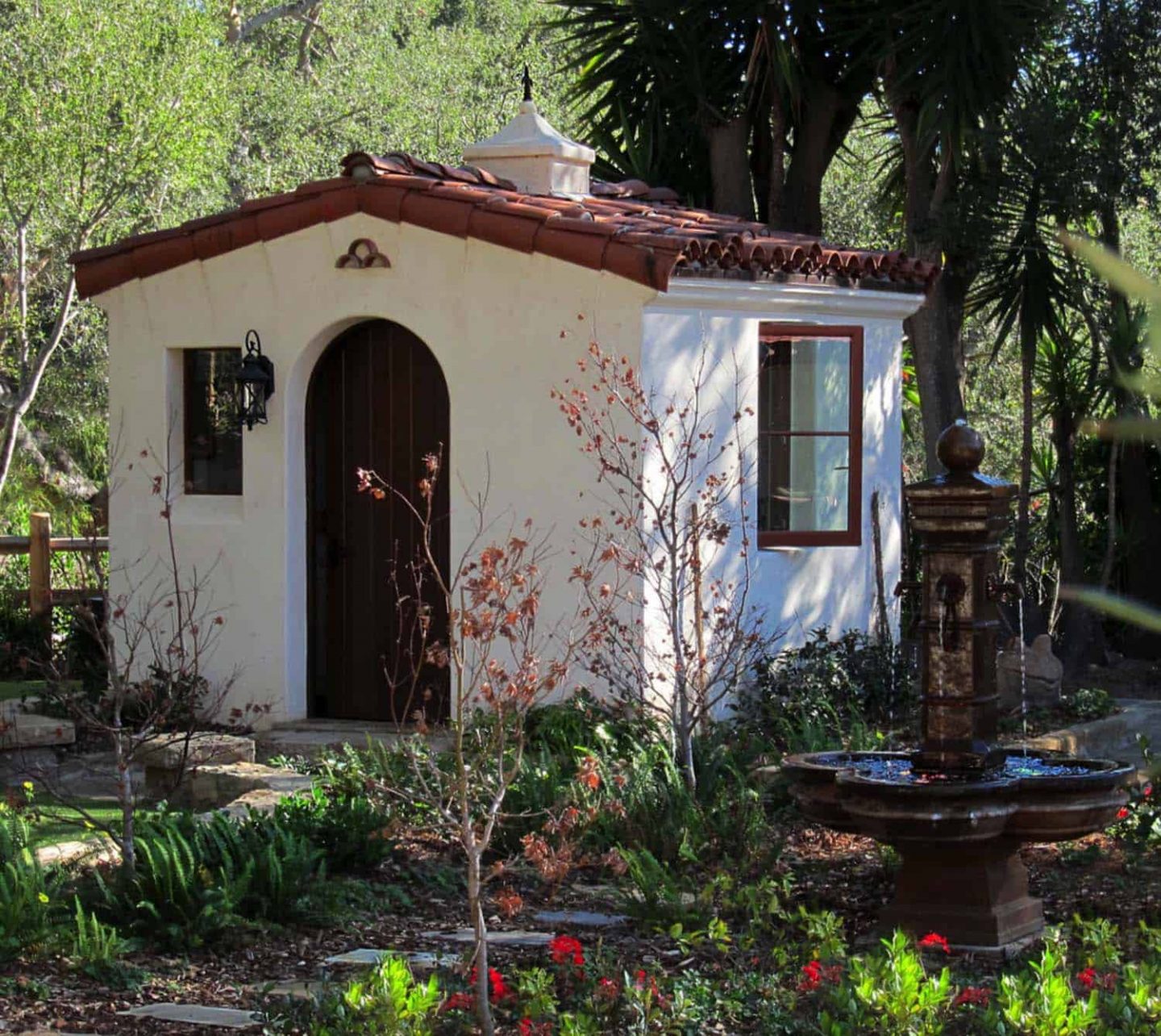 Stunning mini cottage or she shed Spanish style with arched door and tile roof. Come explore She Shed Chic, Potting Shed & Backyard Inspiration.