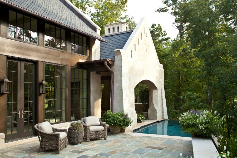 Breathtaking view of magnificent home and pool with design by Jeffrey Dungan on Hello Lovely Studio.