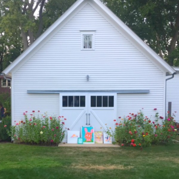 Modern farmhouse garage with sliding barn doors and zinnia flowers. Hello Lovely Studio. Art by Jenny Sweeney. Come explore She Shed Chic, Potting Shed & Backyard Inspiration.