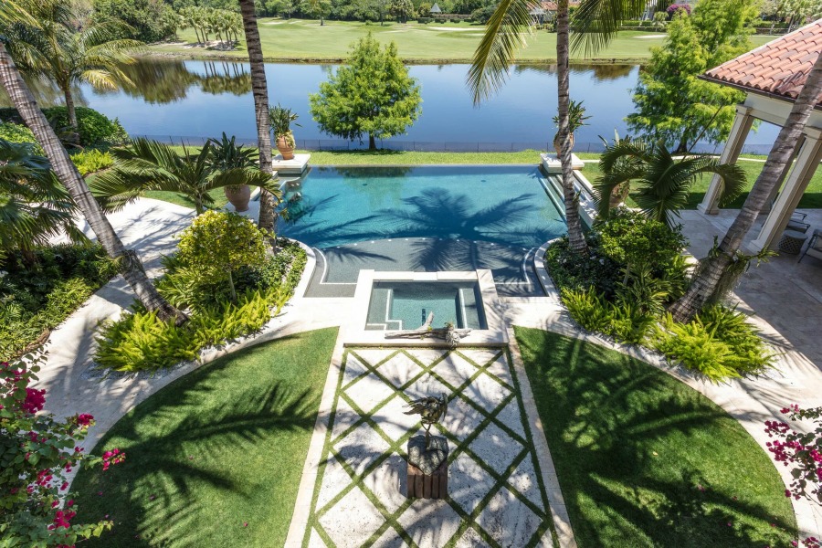 Magnificent pool and tropical oasis with design by Tom Stringer on Hello Lovely Studio.