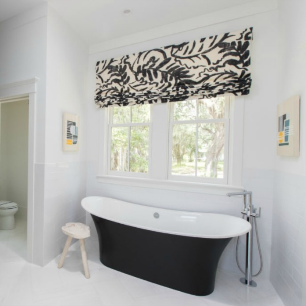 Classic black and white bathroom with soaker tub in a coastal living showhouse with design by Jenny Keenan. #coastalstyle #bathroomdesign #blackandwhite