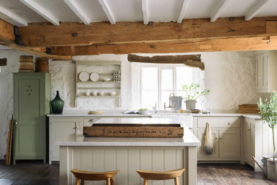 Beautifully rustic English country kitchen in the UK by deVOL has Shaker style cabinetry, farm sink, and a serene palette. #englishcountry #timelesskitchens #bespokekitchendesign