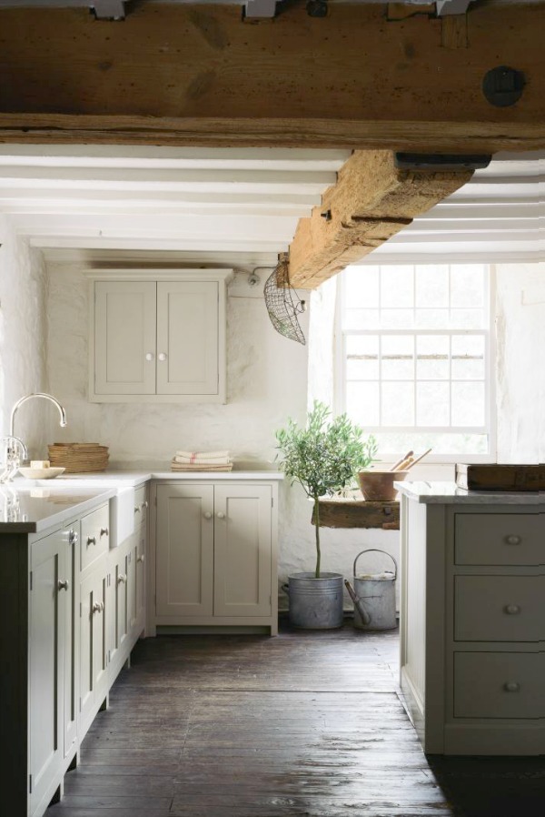 Beautifully rustic English country kitchen in the UK by deVOL has Shaker style cabinetry, farm sink, and a serene palette. #englishcountry #countrykitchen #kitchendesign #rustickitchen #frenchkitchen #shakerkitchen