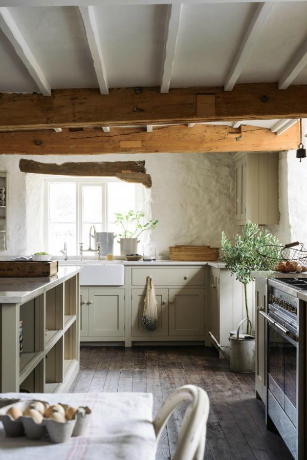 Beautifully rustic English country kitchen in the UK by deVOL has Shaker style cabinetry, farm sink, and a serene palette. #englishcountry #countrykitchen #kitchendesign #rustickitchen #frenchkitchen #shakerkitchen