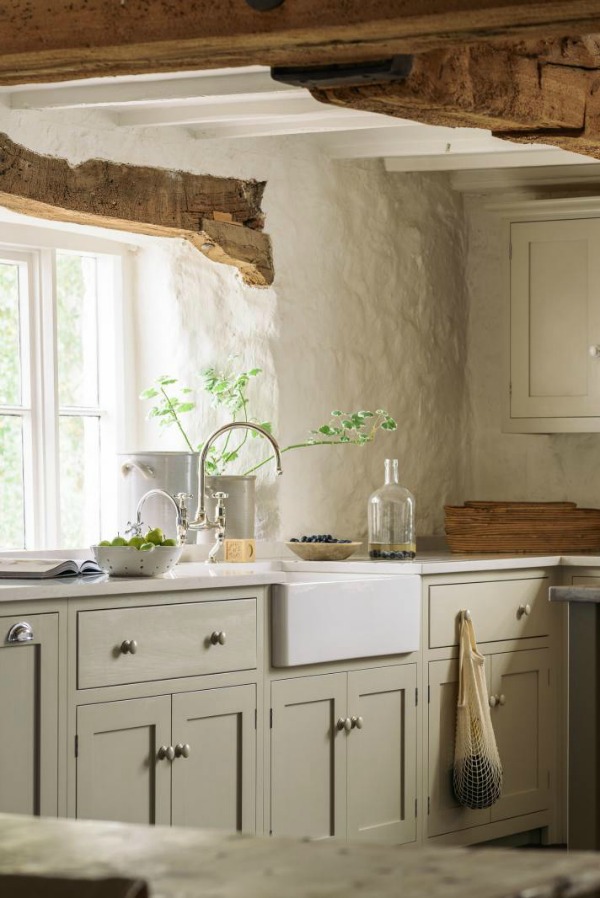 Beautifully rustic English country kitchen in the UK by deVOL has Shaker style cabinetry, farm sink, and a serene palette. #englishcountry #countrykitchen #kitchendesign #rustickitchen #frenchkitchen #shakerkitchen