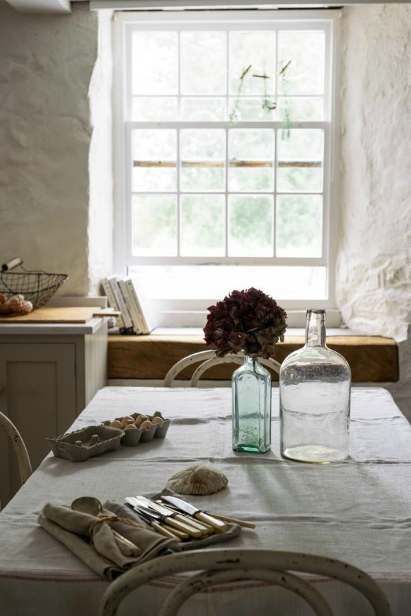 Beautifully rustic English country kitchen in the UK by deVOL has Shaker style cabinetry, farm sink, and a serene palette. #englishcountry #countrykitchen #kitchendesign #rustickitchen #frenchkitchen #shakerkitchen