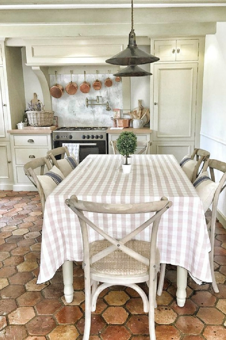 French farmhouse kitchen with reclaimed antique terracotta tile flooring and decor by Vivi et Margot. #frenchfarmhouse #kitchen #frenchkitchen #countryfrench #housesinfrance