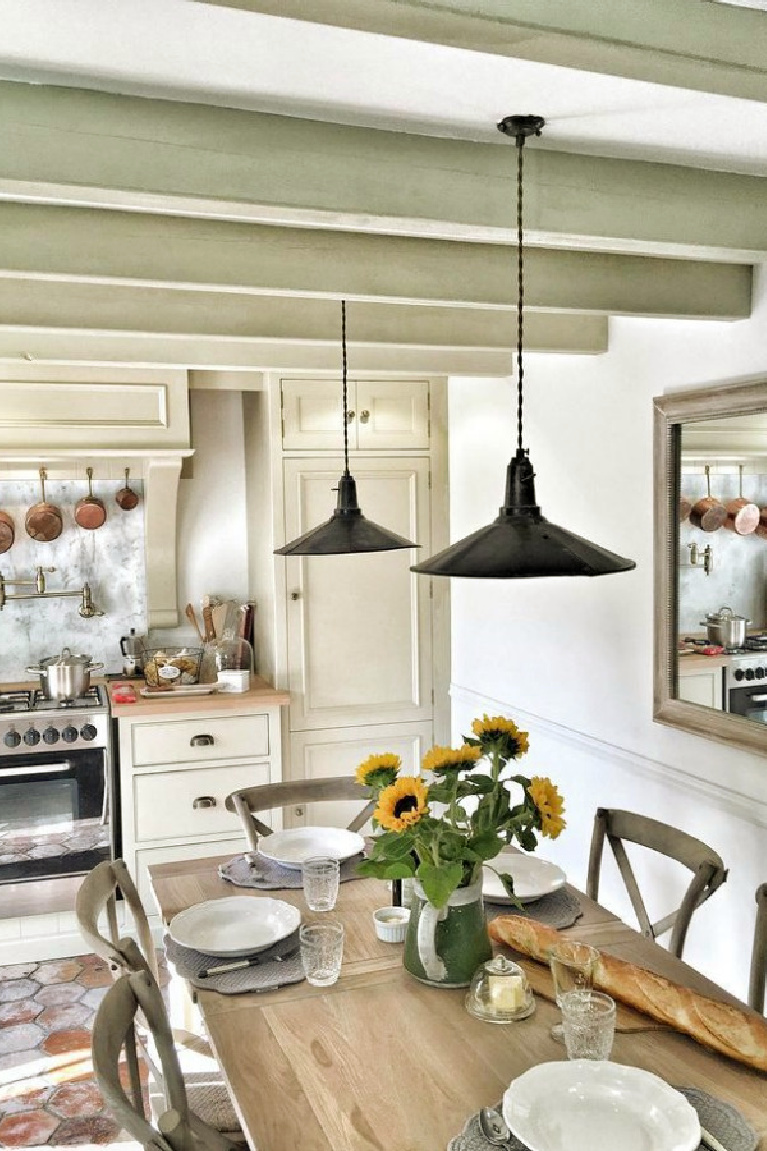 French farmhouse kitchen with reclaimed antique terracotta tile flooring and decor by Vivi et Margot. #frenchfarmhouse #kitchen #frenchkitchen #countryfrench #housesinfrance