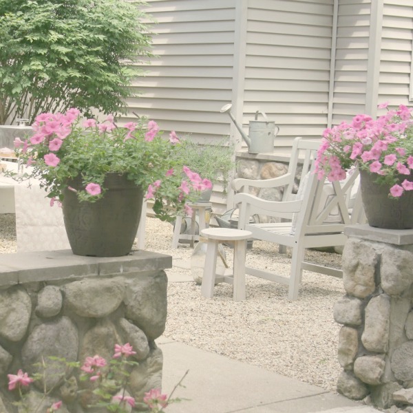 Pink flowers and stone wall in our French courtyard - Hello Lovely Studio.