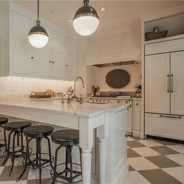 Checkered wood floor and white Lacanche range in beautiful French country kitchen of an elegant historic home with Old World style and beautifully classic European inspired interiors in Marietta Georgia was built for the Kennedy-DuPre family. See more in Traditional Style House Tour: 1935 English Tudor on Hello Lovely Studio.