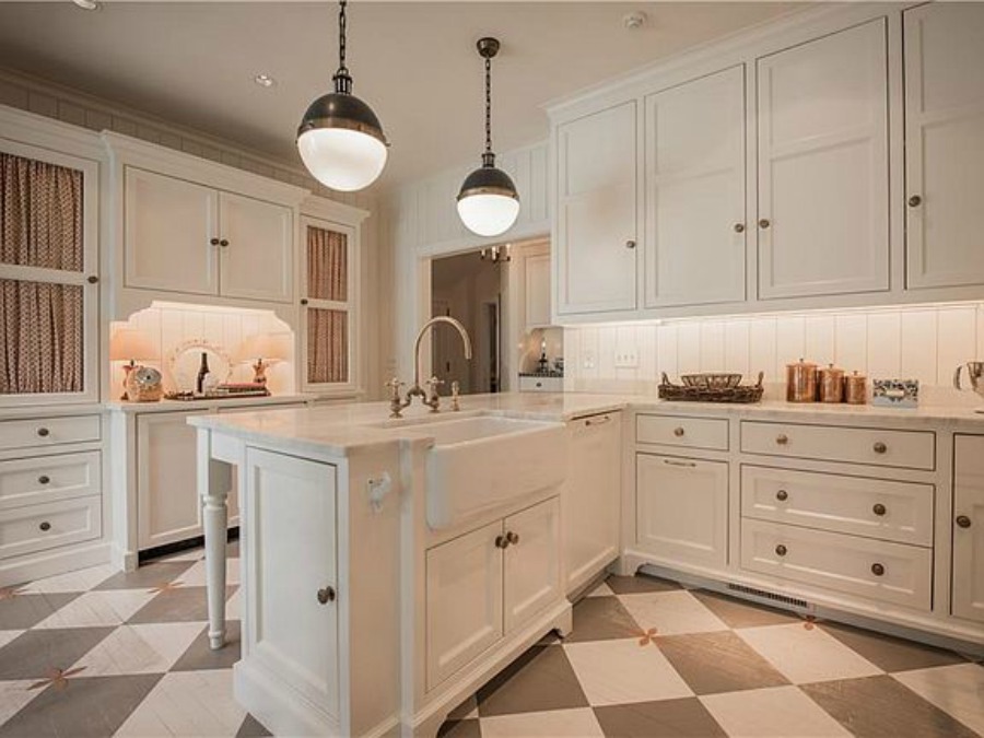 Checkered wood floor in beautiful French country kitchen of an elegant historic home with Old World style and beautifully classic European inspired interiors in Marietta Georgia was built for the Kennedy-DuPre family. ee more of the Entry, Living Room & Kitchen Design Inspiration As Well As Photos of a Beautiful Georgia Tudor Exterior on Hello Lovely Studio.