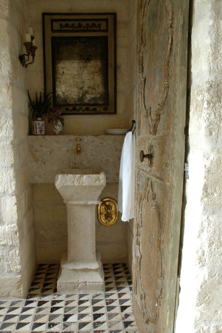 Bathroom. Chateau Domingue antiques and reclaimed stone in a breathtaking Houston home with interior design by Pamela Pierce. #chateaudomingue #frenchfarmhouse #interiordesign #oldworld #pamelapierce #reclaimedstone