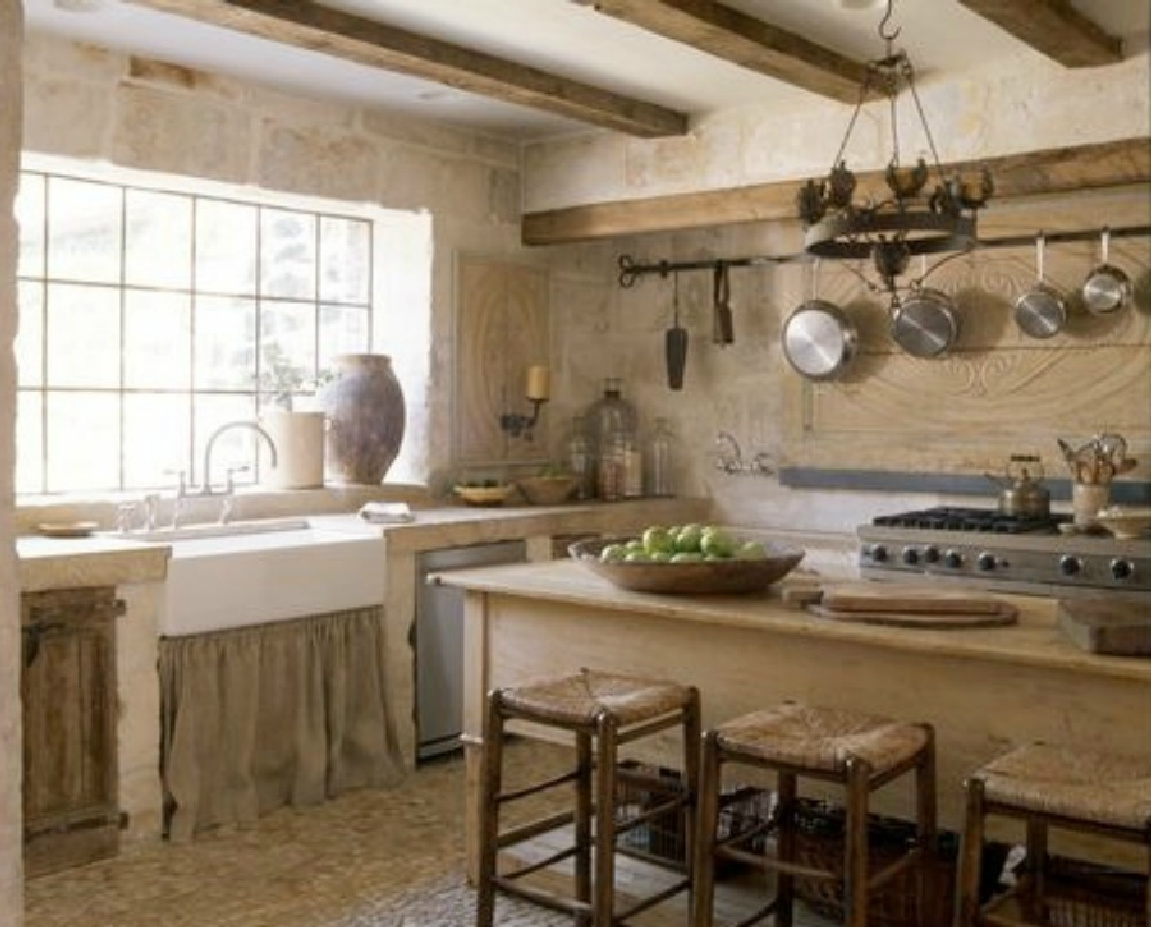 Old world kitchen in Houston. Exquisite reclaimed stone and architectural elements from Europe mix with antiques in a breathtaking room at founder of Chateau Domingue, Ruth Gay's home. #frenchfarmhouse #europeancountry #antiques #chateaudomingue