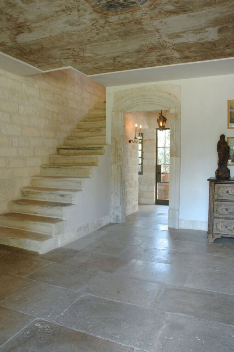 Stone staircase. Exquisite reclaimed stone and architectural elements from Europe mix with antiques in a breathtaking room at founder of Chateau Domingue, Ruth Gay's home. #frenchfarmhouse #europeancountry #antiques #chateaudomingue