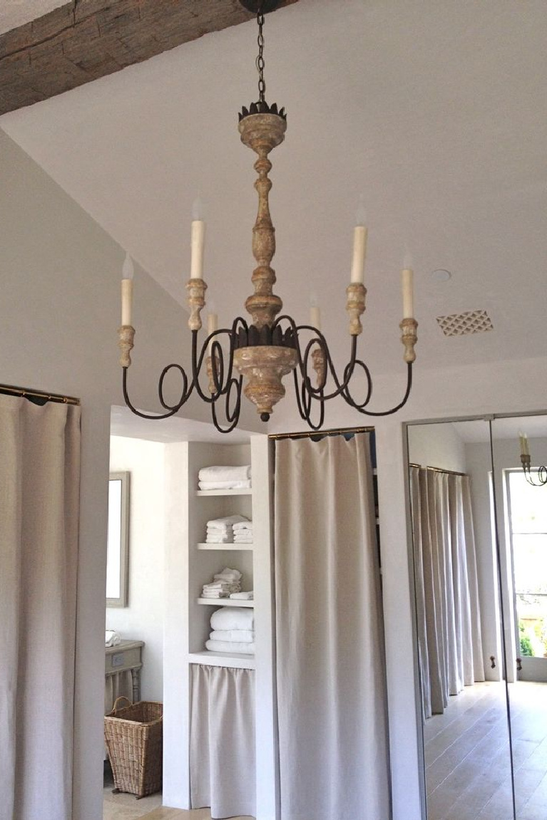 Serene and sophisticated European country French farmhouse style in a dressing room with linen curtains and chandelier at Patina Farm - Brooke Giannetti.