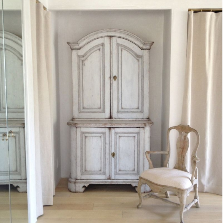 Serene and sophisticated European country French farmhouse style in a dressing room with linen curtains and antiques at Patina Farm - Brooke Giannetti.