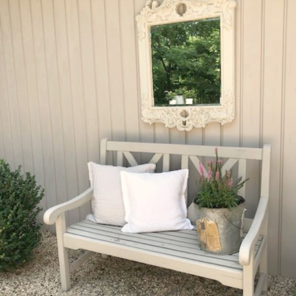 My Farmhouse French inspired courtyard in summer with pea gravel, ferns, galvanized buckets, and boxwood - Hello Lovely Studio.