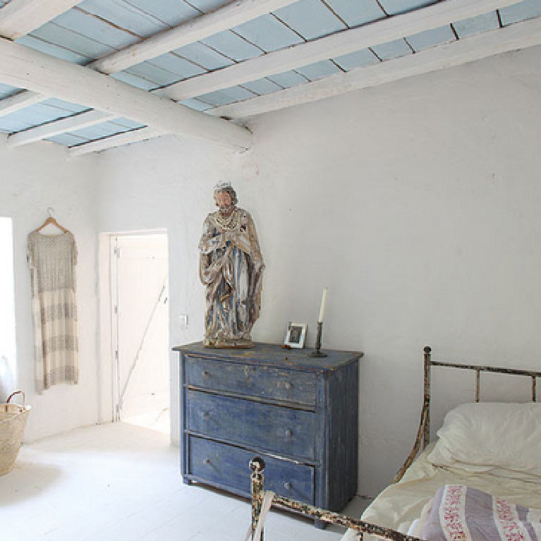 Serene and spare European inspired rustic bedroom with blue wood ceiling and indigo blue dresser - Simply Objekts.