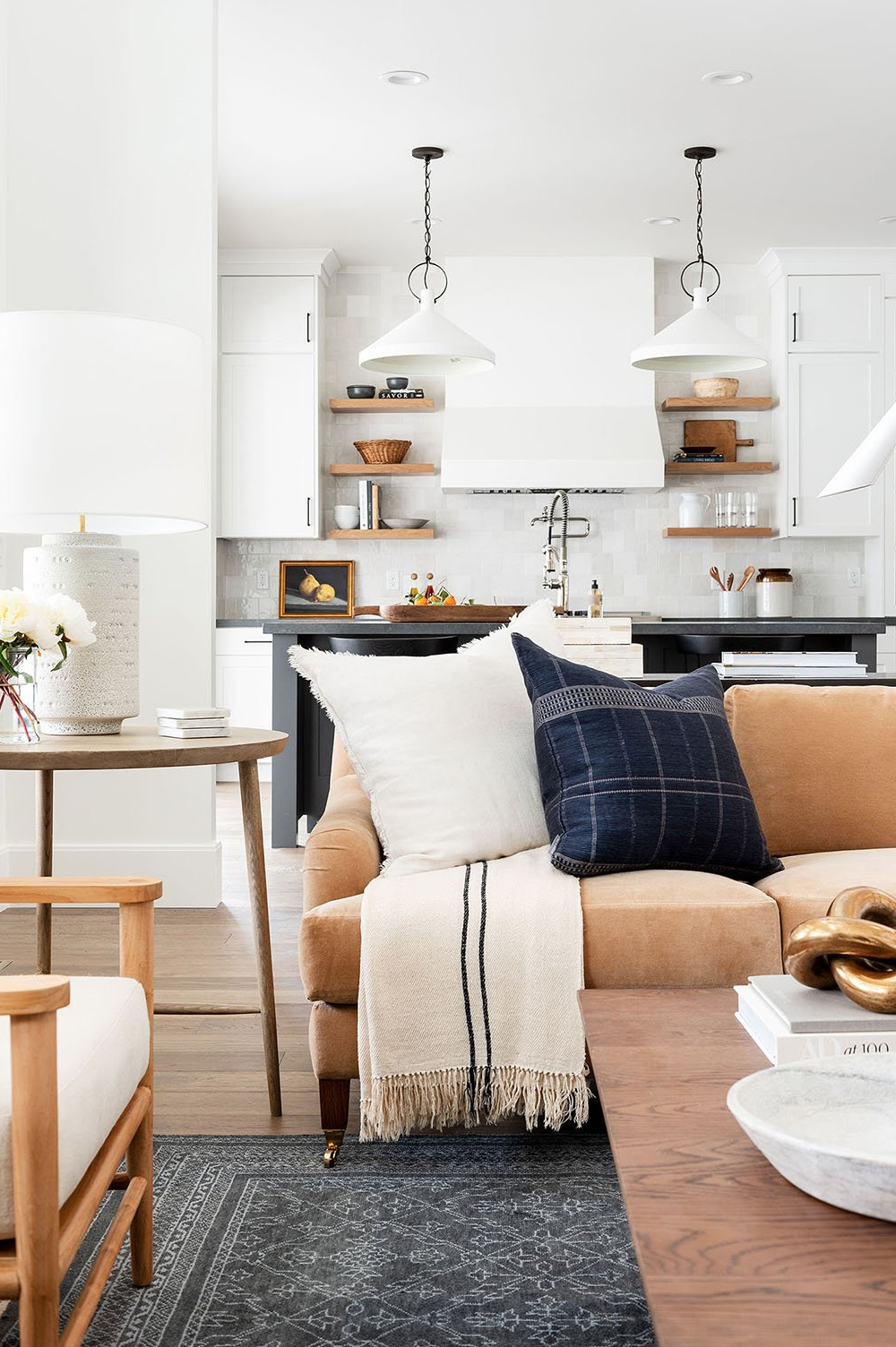 Winston stripe throw (McGee & Co) on a sofa in a classic neutral contemporary great room with white kitchen in background.