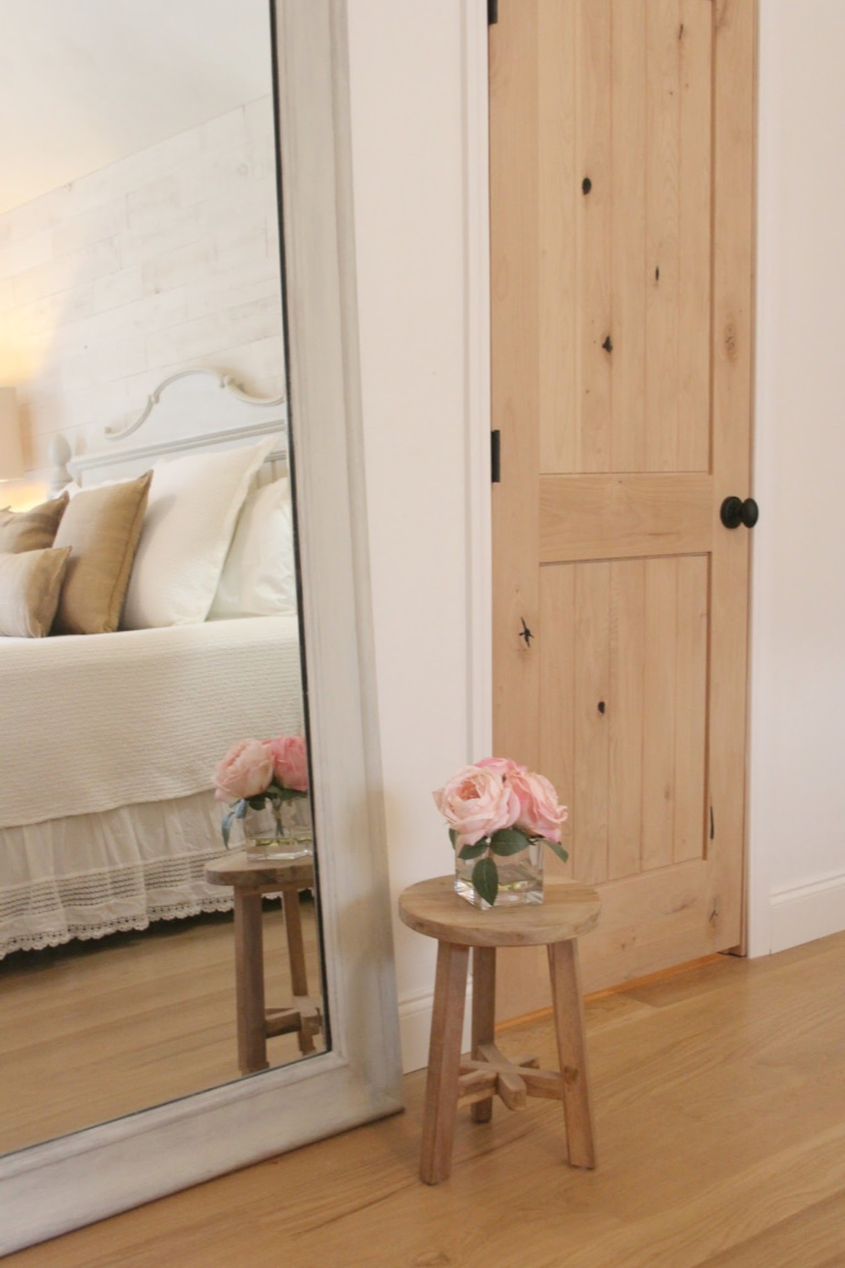 BM White OC-151 on walls in bedroom with knotty alder doors and white oak hardwood. French Nordic style with cottage style furniture painted BM Revere Pewter. #hellolovelystudio #bedroomdecor #knottyalder #europeancountry