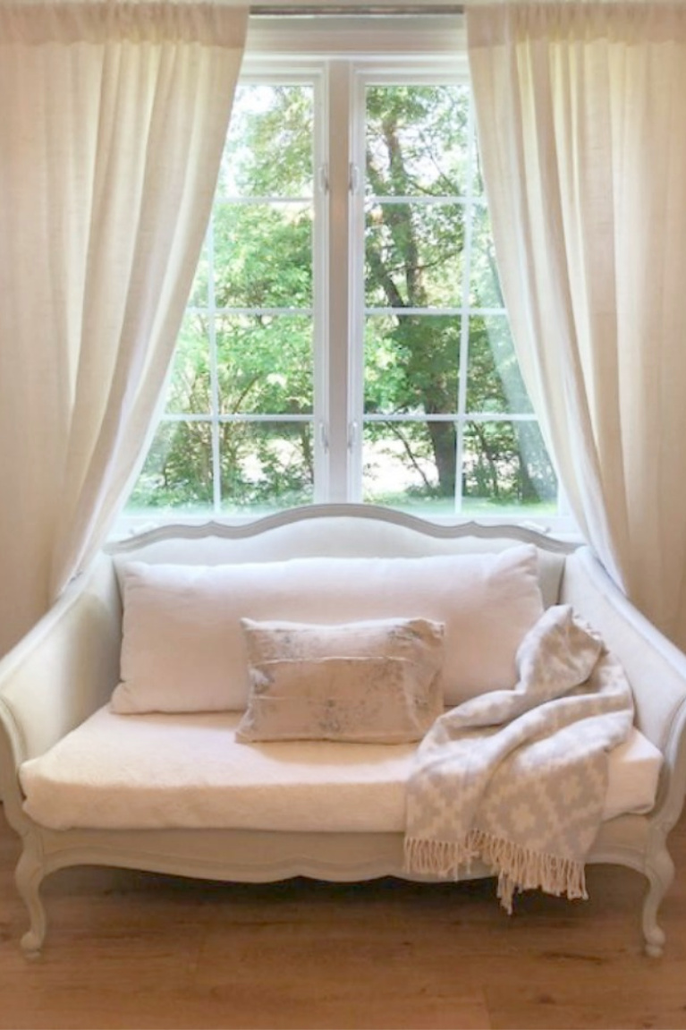 White Belgian linen drapes and a French settee in our French inspired cottage. #hellolovelystudio #frenchcountry #whitelinen #frenchsettee #interiordesign #europeancountry