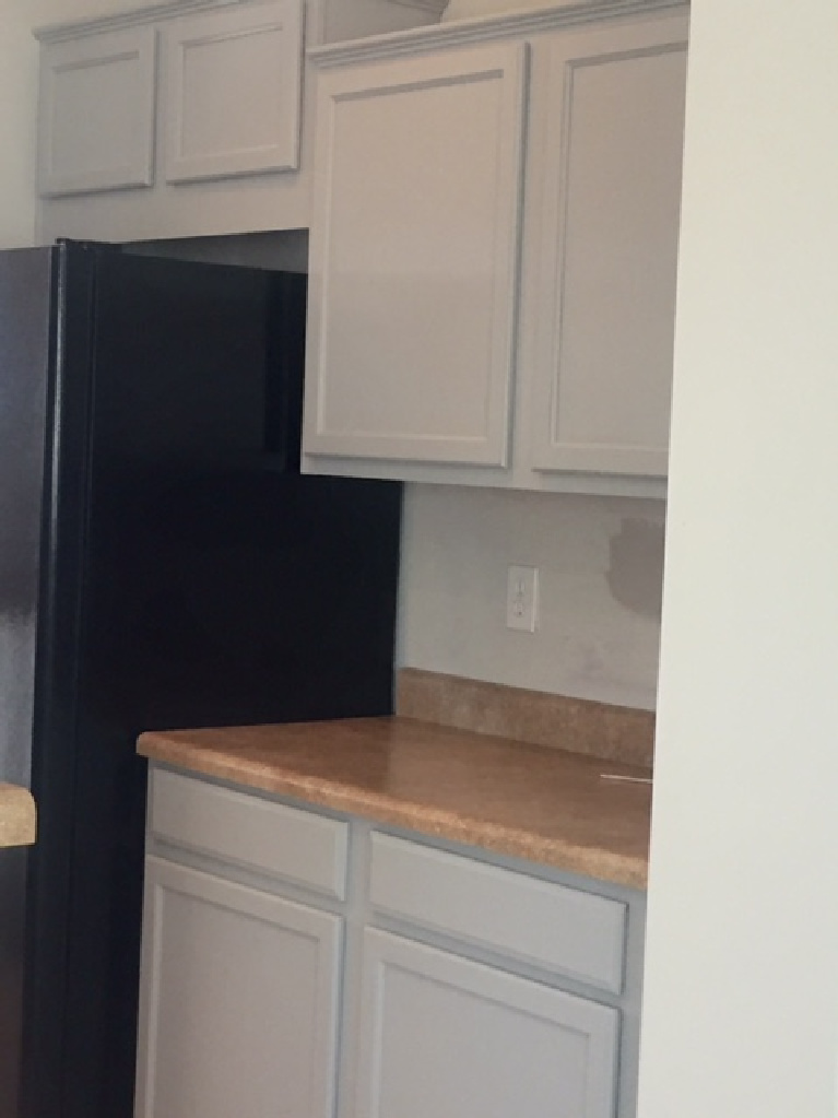 Serene kitchen makeover with Viatera white quartz (Soprano), painted cabinets (Behr Classic Silver), hardware (Top Knobs), and Kitchenaid Smudgeproof appliances - Hello Lovely Studio. #kitchenmakeover #beforeafter #diykitchenreno #kitchendesign #paintedcabinets #viateraquartz #soprano #homereno