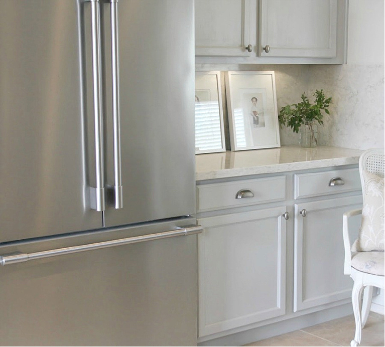 Hello Lovely's Kitchen Makeover with Viatera Soprano quartz counters, Kitchenaid stainless appliances, and blue grey cabinets. #hellolovelystudio #kitchenmakeover #diykitchendesign #paintedcabinets #viaterasoprano #whitequartzcounters #kitchenaidappliances