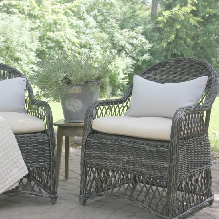 Grey rattan patio chairs with ivory cushions and light grey Belgian linen lumbar pillows. #hellolovelystudio #patiochairs #europeancountry #patiofurniture #outdoorfuniture #belgianlinen