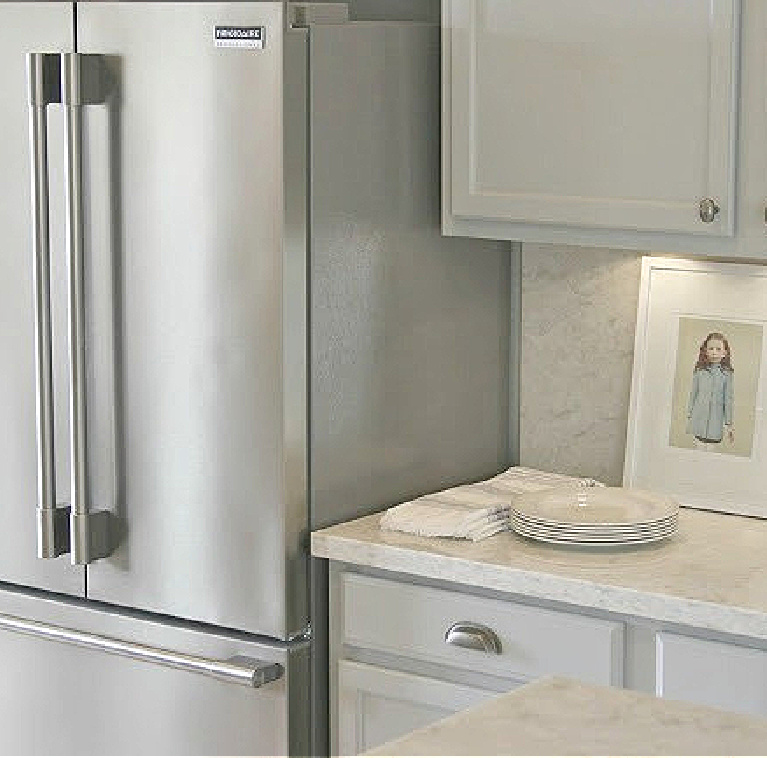 Hello Lovely's Kitchen Makeover with Viatera Soprano quartz counters, Kitchenaid stainless appliances, and blue grey cabinets. #hellolovelystudio #kitchenmakeover #diykitchendesign #paintedcabinets #viaterasoprano #whitequartzcounters #kitchenaidappliances