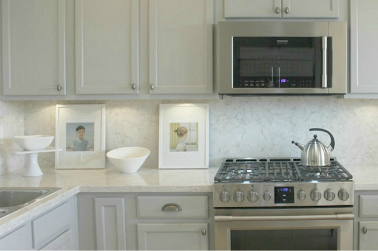 Viatera Soprano quartz kitchen counters and backsplash with Behr Classic Silver painted blue grey cabinets - Hello Lovely Studio. #viateraquartz #soprano #bluegreykitchen #kitchendesign #kitchenmakeover #serenekitchen #behrclassicsilver