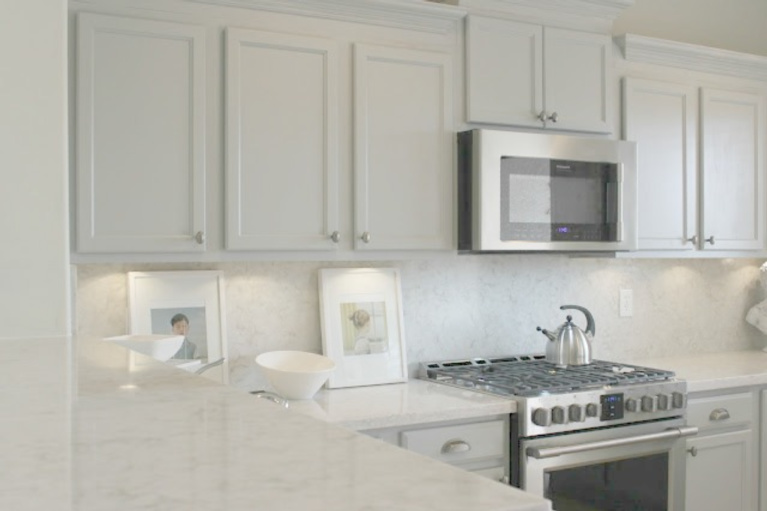 Viatera Soprano quartz kitchen counters and backsplash with Behr Classic Silver painted blue grey cabinets - Hello Lovely Studio. #viateraquartz #soprano #bluegreykitchen #kitchendesign #kitchenmakeover #serenekitchen #behrclassicsilver