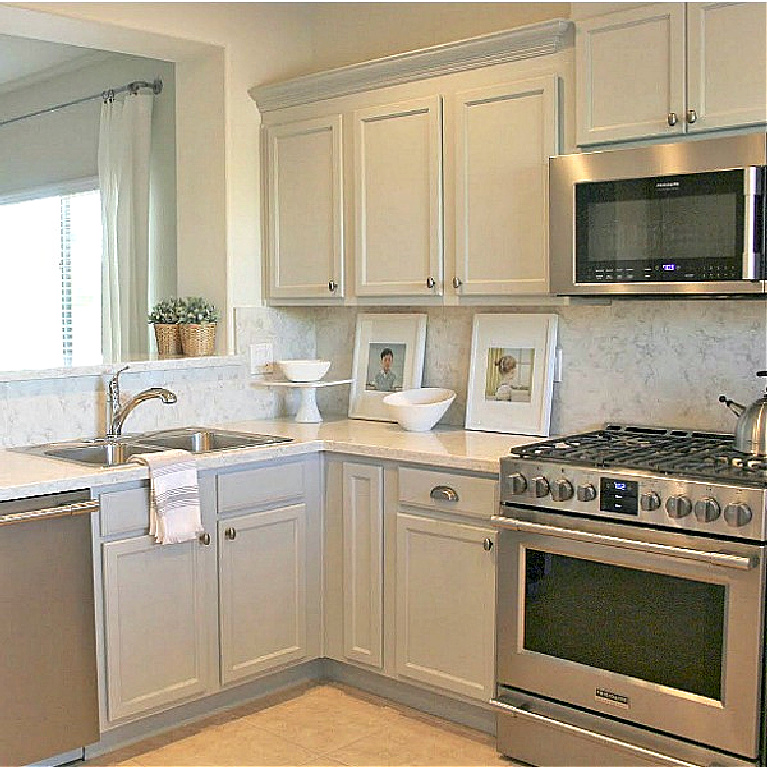 Viatera Soprano quartz kitchen counters and backsplash with Behr Classic Silver painted blue grey cabinets - Hello Lovely Studio. #viateraquartz #soprano #bluegreykitchen #kitchendesign #kitchenmakeover #serenekitchen #behrclassicsilver