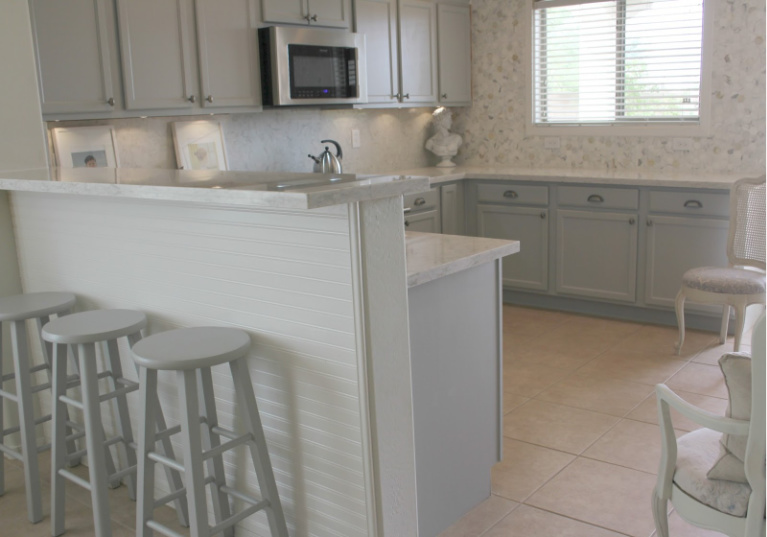 Viatera Soprano quartz kitchen counters and backsplash with Behr Classic Silver painted blue grey cabinets - Hello Lovely Studio. #viateraquartz #soprano #bluegreykitchen #kitchendesign #kitchenmakeover #serenekitchen #behrclassicsilver