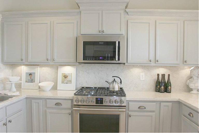 Viatera Soprano quartz kitchen counters and backsplash with Behr Classic Silver painted blue grey cabinets - Hello Lovely Studio. #viateraquartz #soprano #bluegreykitchen #kitchendesign #kitchenmakeover #serenekitchen #behrclassicsilver