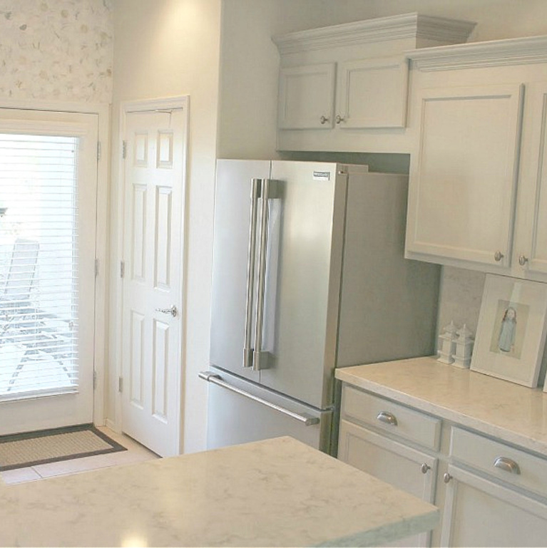 Viatera Soprano quartz kitchen counters and backsplash with Behr Classic Silver painted blue grey cabinets - Hello Lovely Studio. #viateraquartz #soprano #bluegreykitchen #kitchendesign #kitchenmakeover #serenekitchen #behrclassicsilver