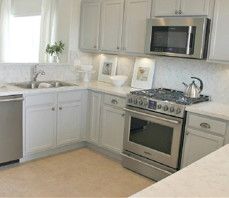 Viatera Soprano quartz kitchen counters and backsplash with Behr Classic Silver painted blue grey cabinets - Hello Lovely Studio. #viateraquartz #soprano #bluegreykitchen #kitchendesign #kitchenmakeover #serenekitchen #behrclassicsilver