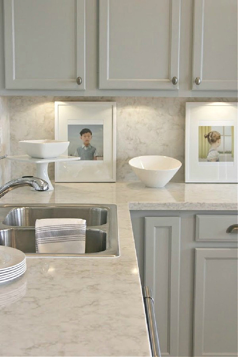 Viatera Soprano quartz kitchen counters and backsplash with Behr Classic Silver painted blue grey cabinets - Hello Lovely Studio. #viateraquartz #soprano #bluegreykitchen #kitchendesign #kitchenmakeover #serenekitchen #behrclassicsilver