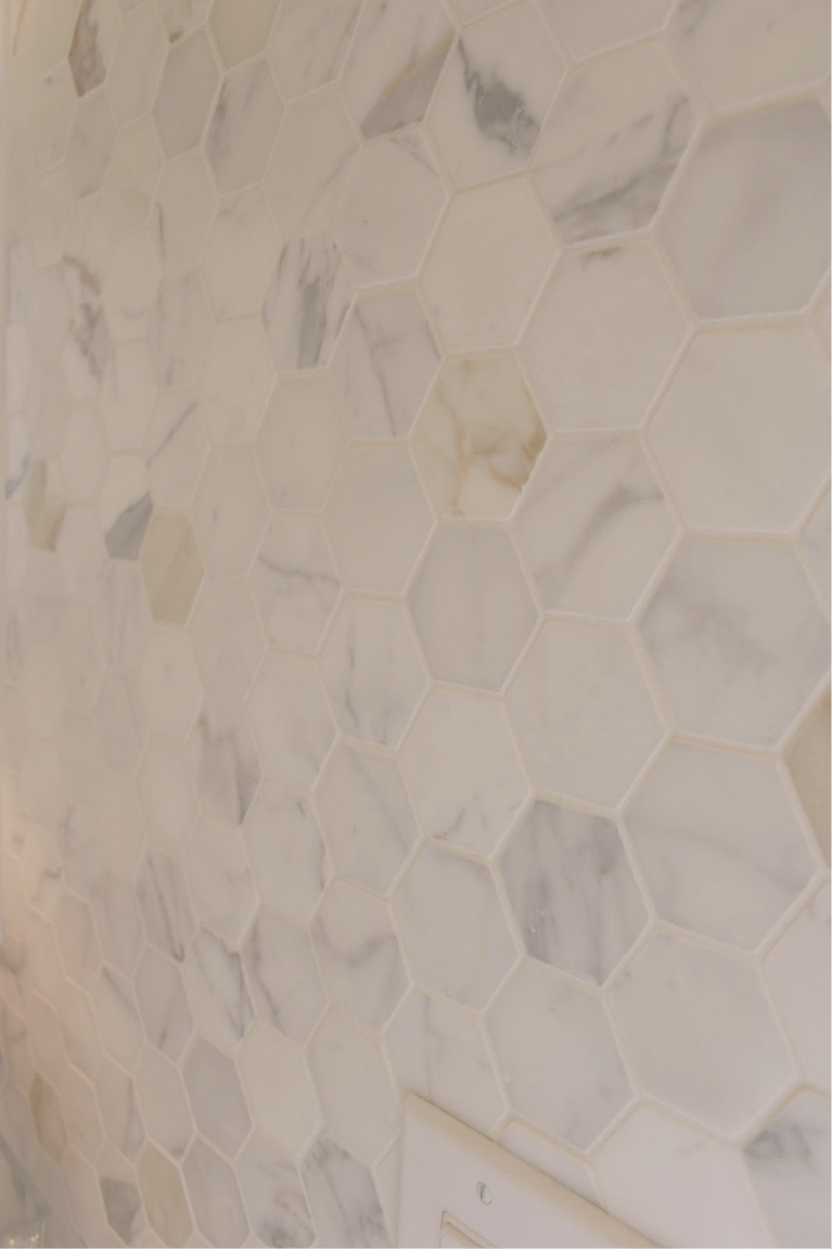 Calacatta gold marble hex tiles on statement wall of our kitchen - Hello Lovely Studio. #calacattagold #marbletile #hextile #kitchendesign