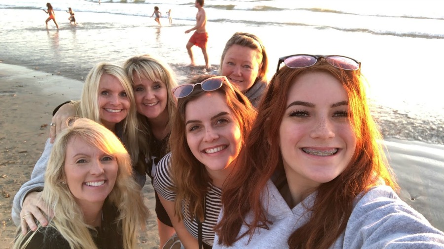 Reflections from a Previvor - Six women smiling at the beach - Hello Lovely Studio. Come hear about What It's Like Living With Breast Cancer Genetic Mutation: Soulful Reflections From a Previvor As Well As Information About BRCA and Hereditary Cancer.