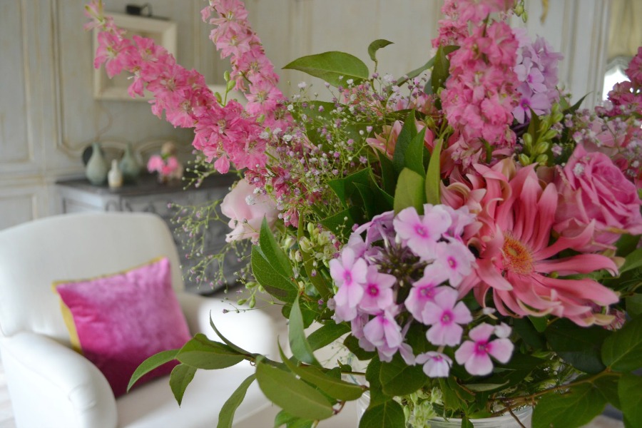 Bold pink floral arrangement. Photo gallery of Greet  Lefèvre's Belgian home with interior design inspiration (photos by Claude Smekens and Belgian Pearls). Fall in love with enchanting gardens and traditional Belgian architecture and sophistication. #belgianinteriors #europeancountry #rusticelegance