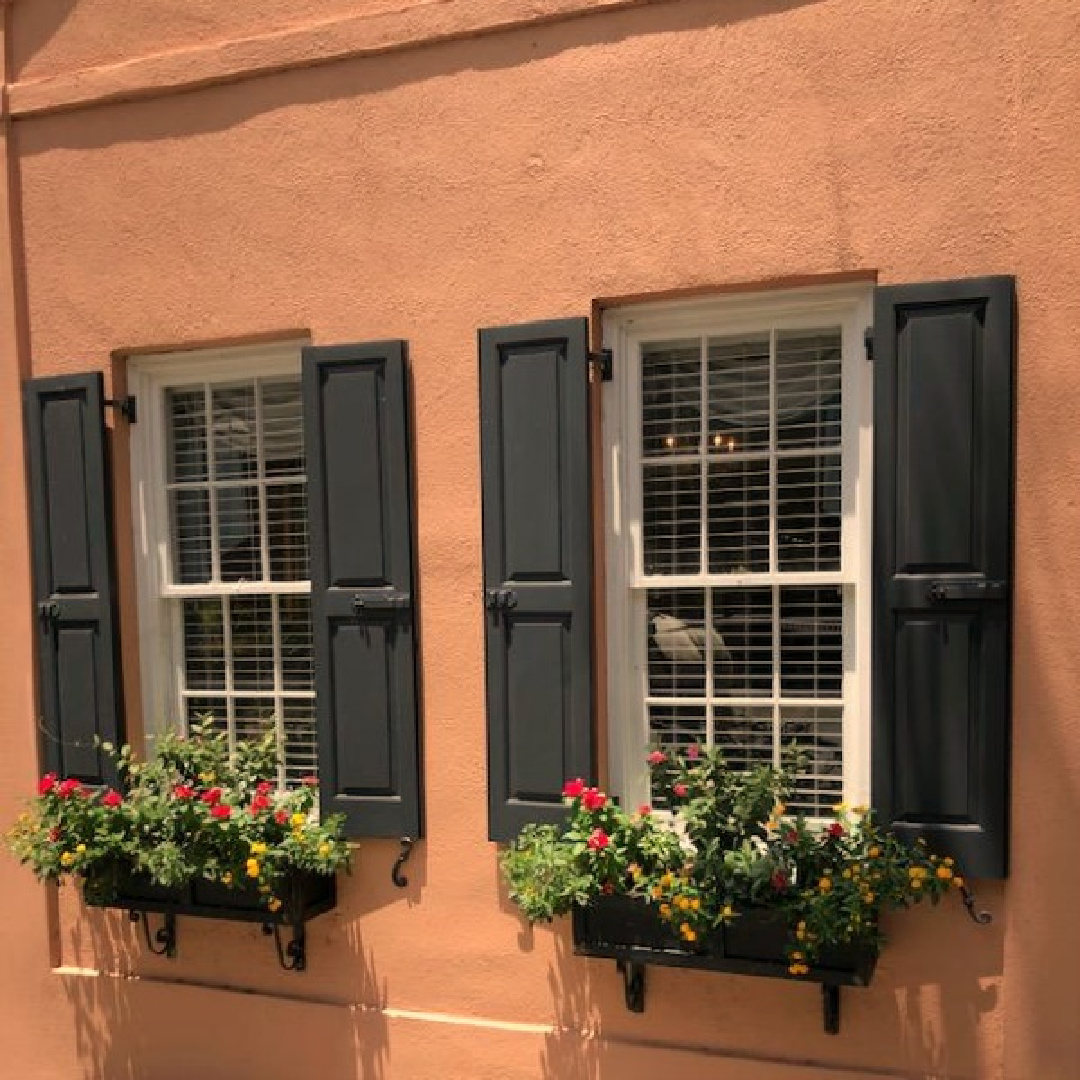 Charleston's charming historic district is graced with architecturally magnificent homes, secret gardens, lush window boxes, and colorful design inspiration. Come enjoy this photo gallery with Historic Charleston Mansion Exteriors on Hello Lovely Studio. #charlestonhomes #charlestongardens