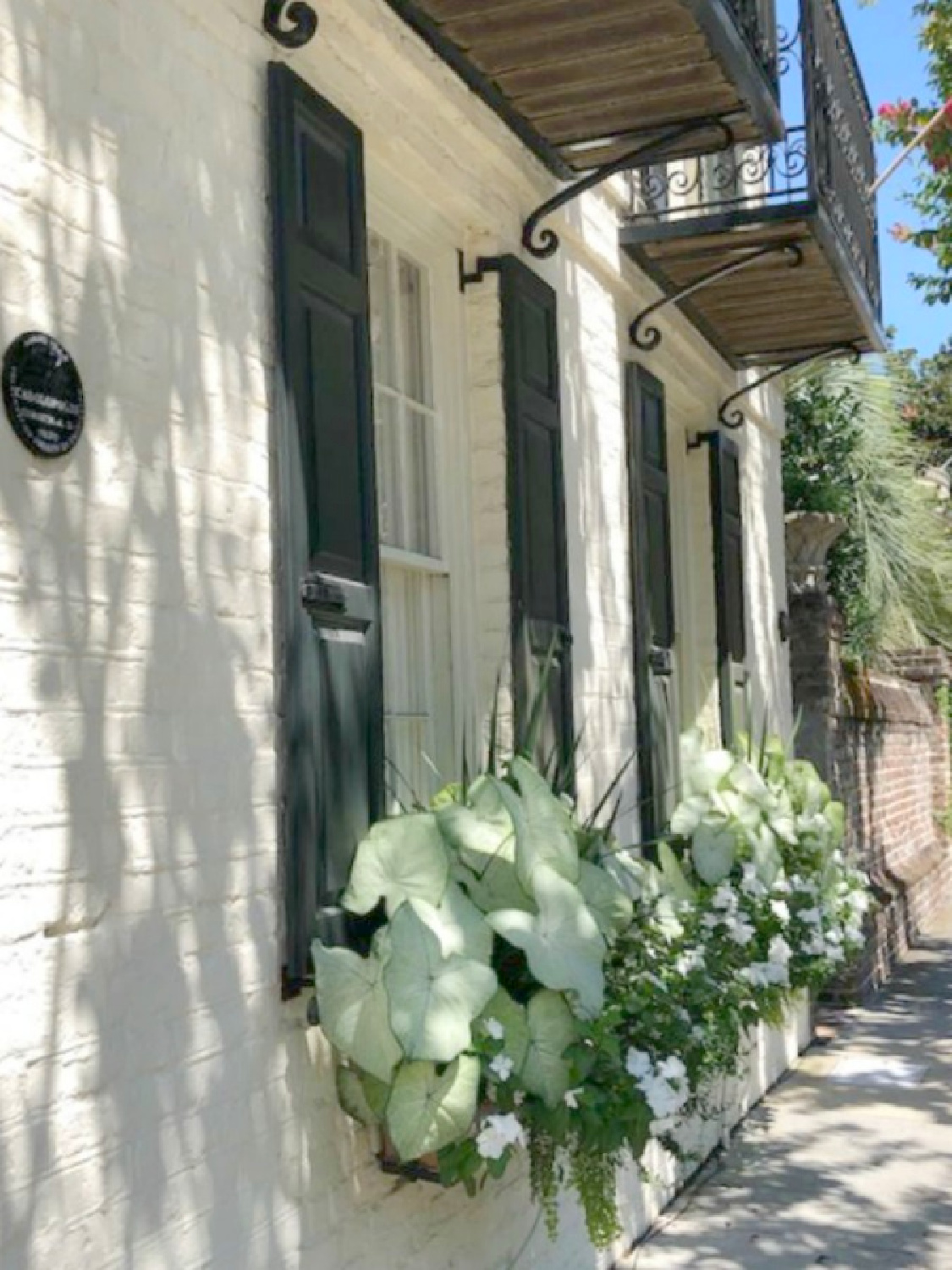 Charleston's charming historic district is graced with architecturally magnificent homes, secret gardens, lush window boxes, and colorful design inspiration. Come enjoy this photo gallery with Historic Charleston Mansion Exteriors on Hello Lovely Studio. #charlestonhomes #charlestongardens