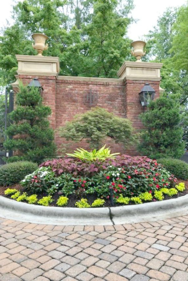 Beautiful landscaping graces the entrance to a luxurious neighborhood in Charlotte, NC. Hello Lovely Studio.