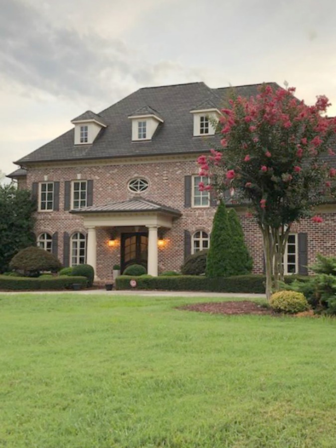 This charming home exterior in Charlotte, NC, boasts curb appeal, traditional design, and inspiring architectural details - Hello Lovely Studio.