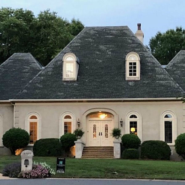 This charming home exterior in Charlotte, NC, boasts curb appeal, traditional design, and inspiring architectural details - Hello Lovely Studio.