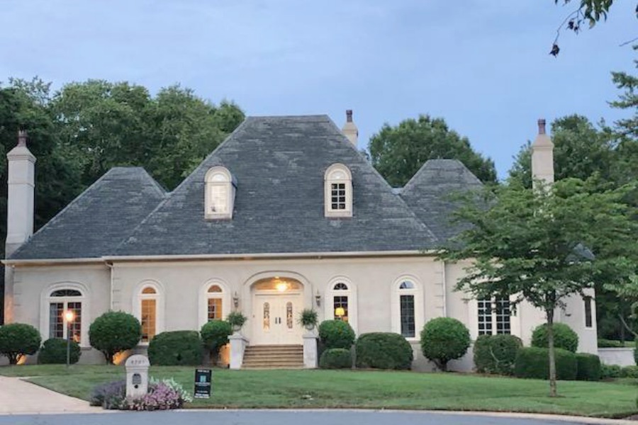 This charming home exterior in Charlotte, NC, boasts curb appeal, traditional design, and inspiring architectural details - Hello Lovely Studio.